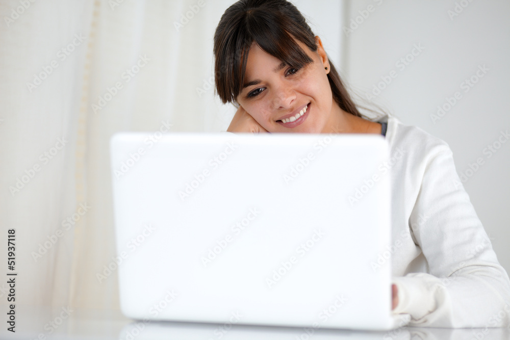 Positive young woman using her laptop computer Positive young woman using her laptop computer