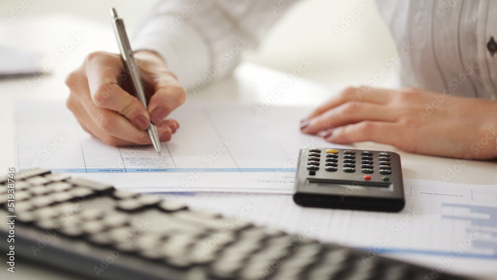 accountant making calculations and taking notes