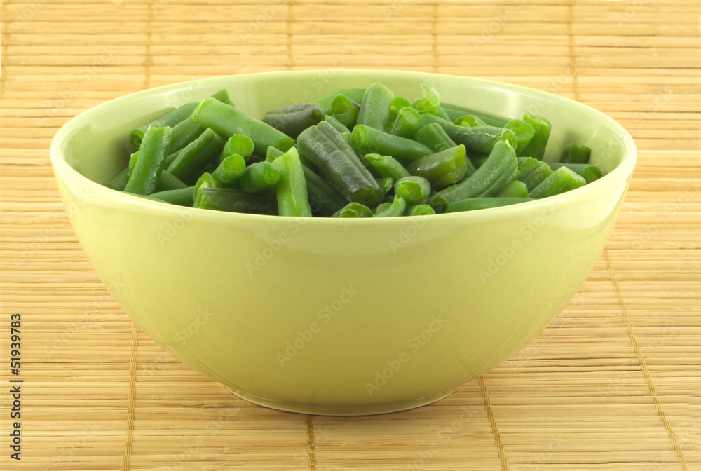 Green beans and cauliflower in a bowl on a wicker mat Green beans and cauliflower in a bowl on a wicker mat