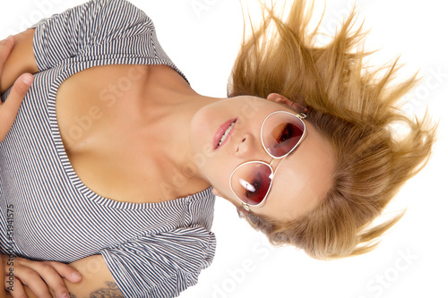 Young beautiful woman lying in sunglasses