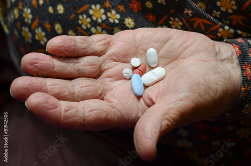 pills on palm of a senior person
