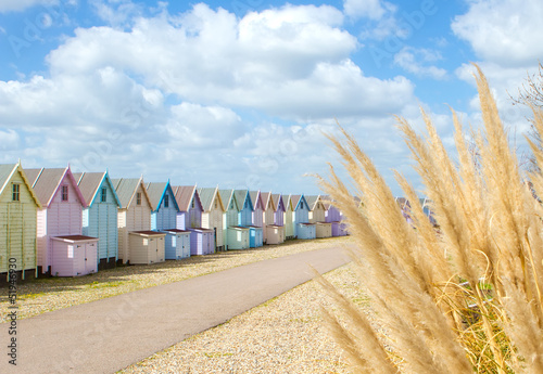 Traditional British beach huts on a bright sunny day