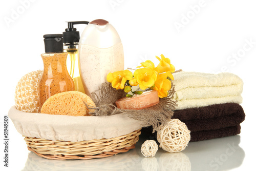 Composition of cosmetic bottles and soap in basket, isolated