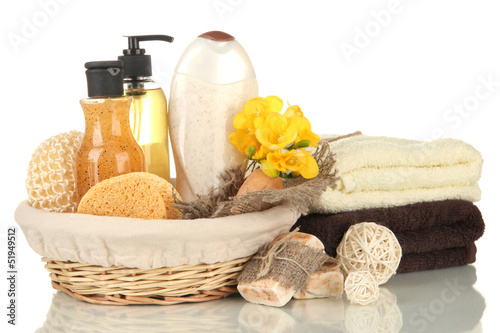 Composition of cosmetic bottles and soap in basket, isolated