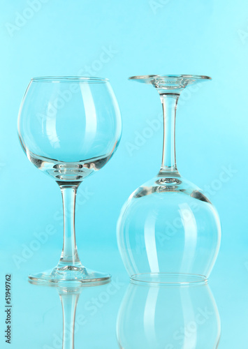 Two glasses on light blue background