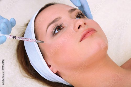 Young woman receiving plast...
