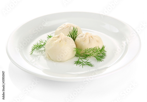 Tasty khinkali on plate, isolated on white