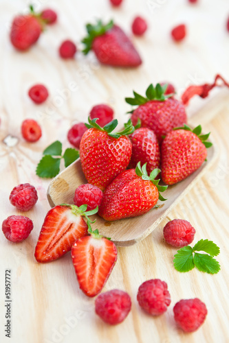 Fresh strawberries on a wooden scoop