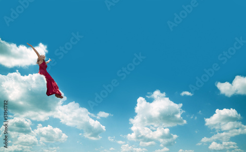 chica sentada en una nube.Concepto de felicidad y libertad © C.Castilla