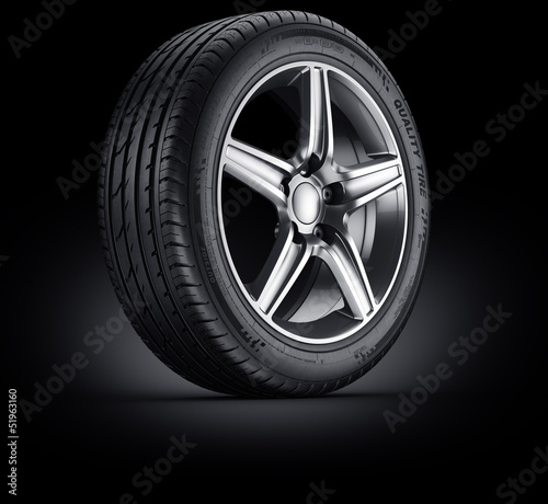 Car tire on black background photo