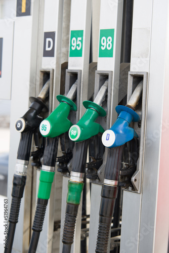 Detail of hoses of petrol pump at a gas station, selective focus