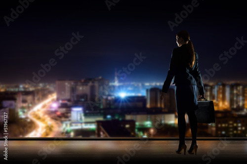 Business woman standing at the window