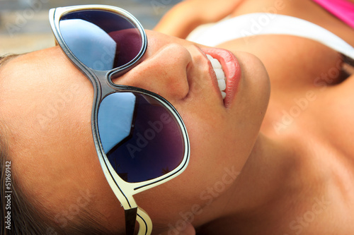 Pretty young woman relaxed by the pool