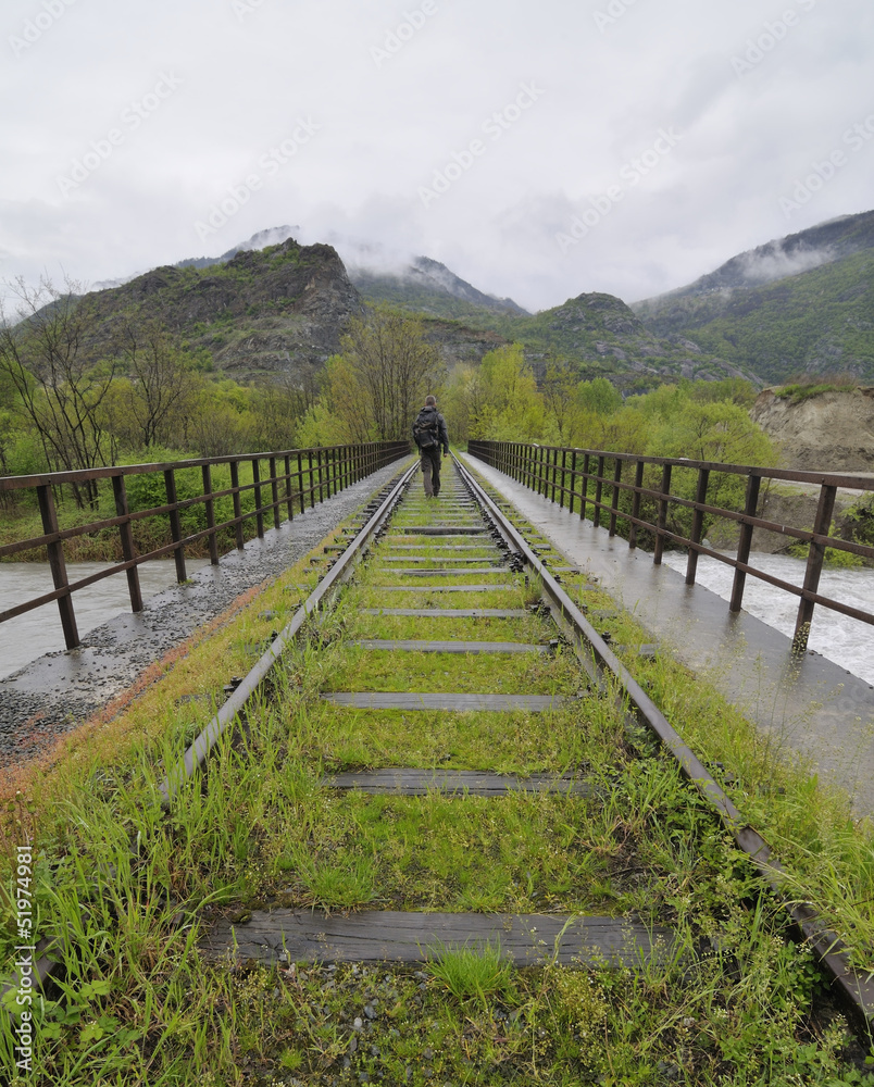 hiker on an abandoned railway