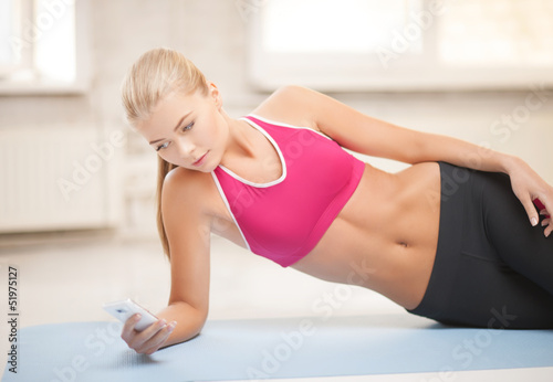 woman lying on the floor with smartphone
