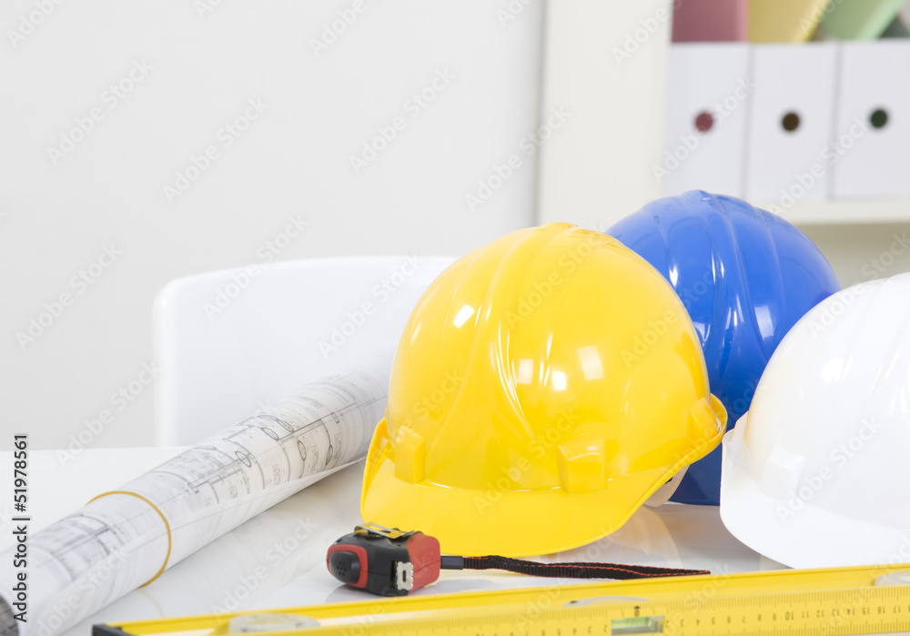 Hardhat and measuring instruments on blueprint Hardhat and measuring instruments on blueprint