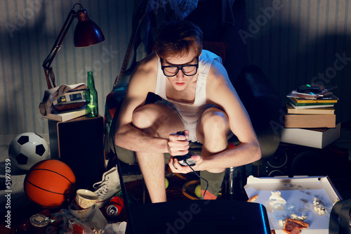 Gamer nerd playing video games on television photo