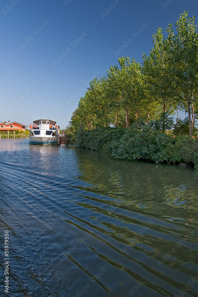 Pleasure boat anchored on a calm river Pleasure boat anchored on a calm river