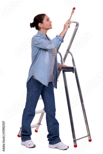 Female decorator stood by step-ladder