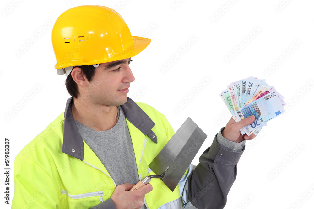 Young builder with a handful of cash Young builder with a handful of cash