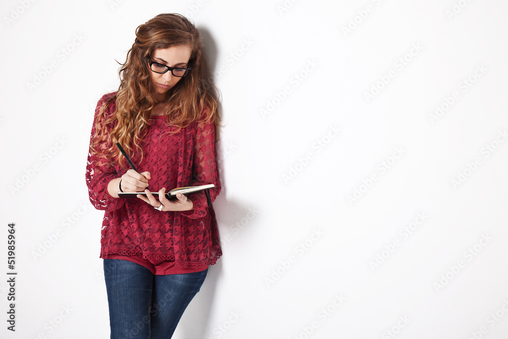 Female student writing on notebook Female student writing on notebook