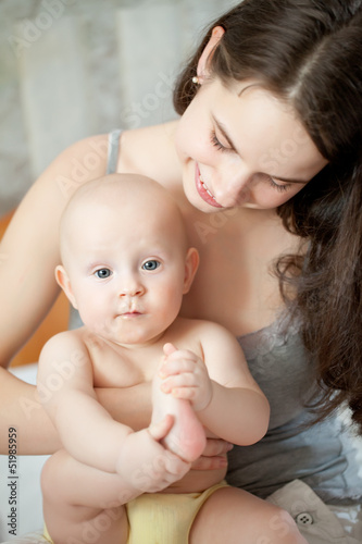 happy-looking baby and mother playing together