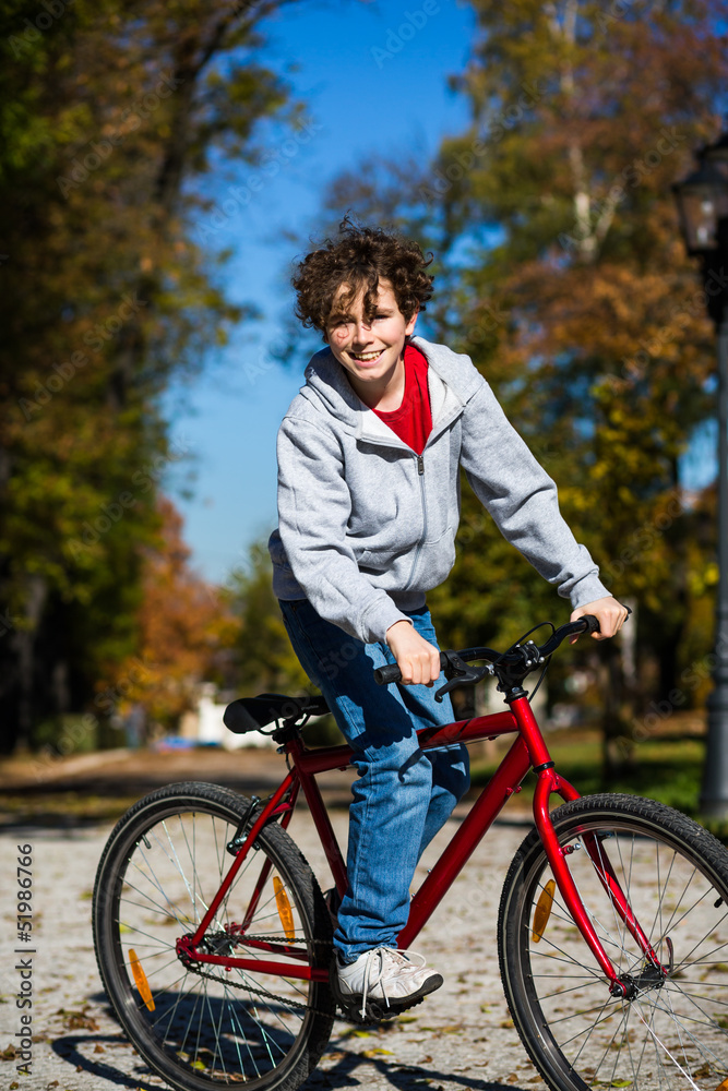 Urban biking - teenage boy and bike in city park