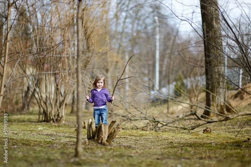 Adorable little girl having fun in a park