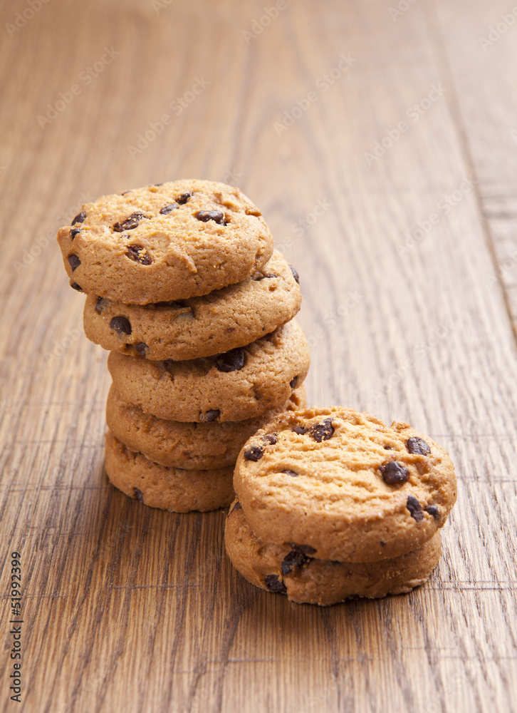 stack of chocolate biscuits with chocolate on wooden table stack of chocolate biscuits with chocolate on wooden table