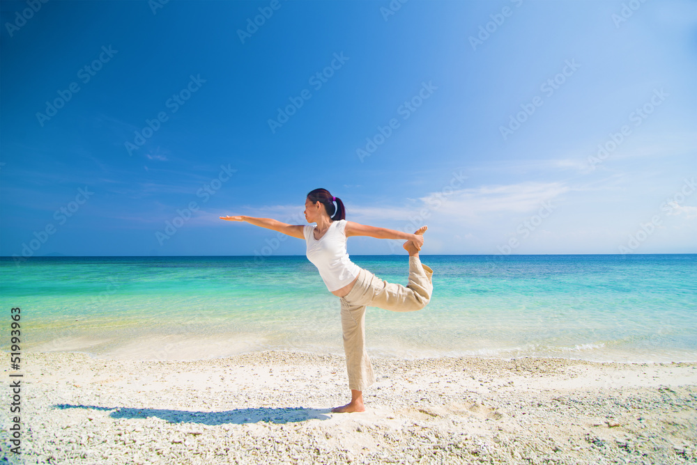 beach yoga performed by a matured asian female beach yoga performed by a matured asian female