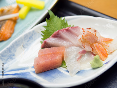 Mixed sashimi, raw fish, on traditional japanese plate
