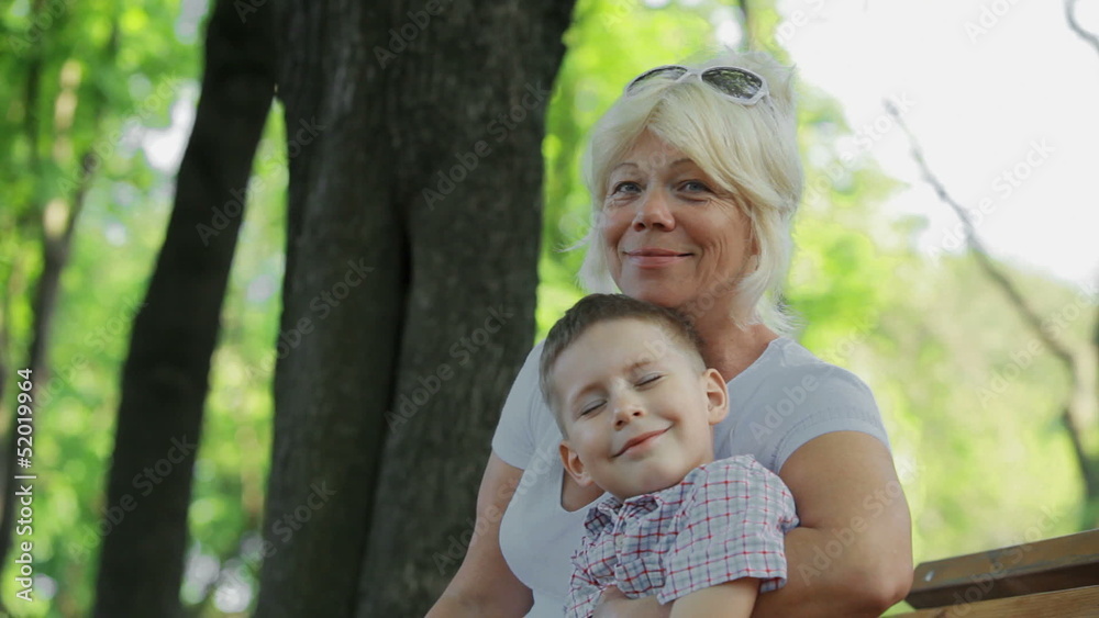 Grandmother with grandson sitting in the park Grandmother with grandson sitting in the park