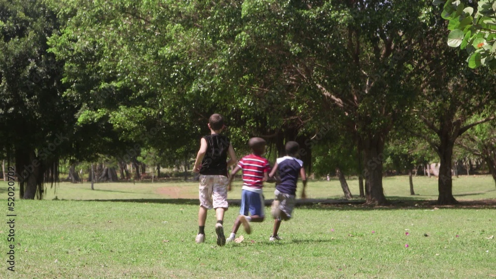 Children running and playing, group of friends in city park Children running and playing, group of friends in city park