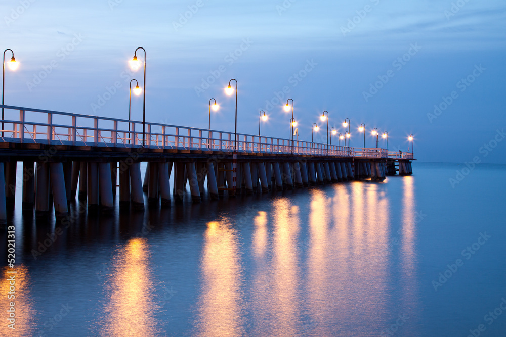 Sunrise on the pier at the seaside, Gdynia Orlowo, Poland.