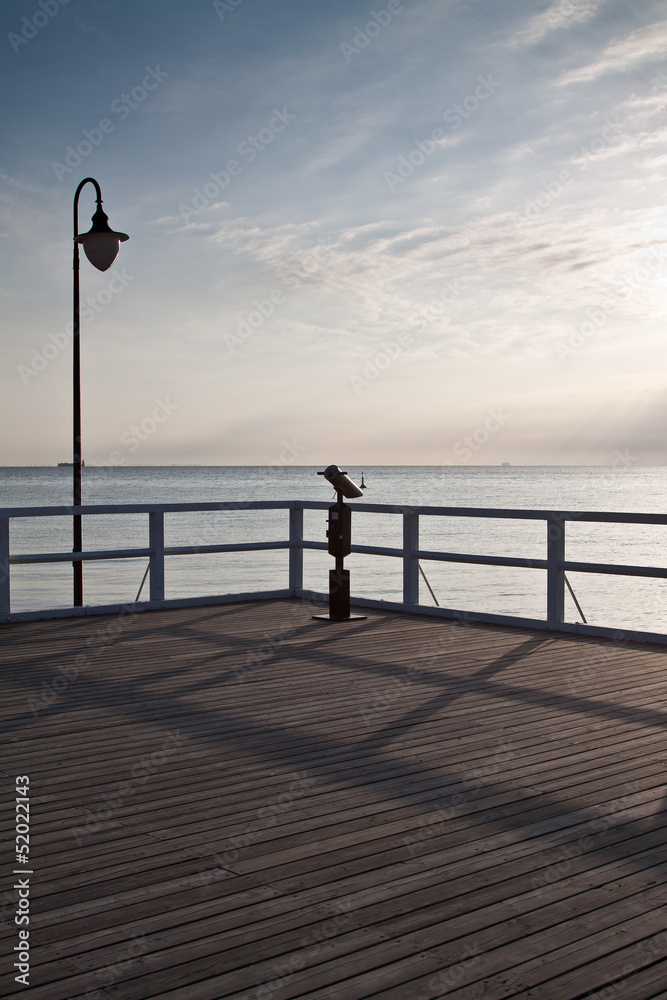 Sunrise on the pier at the seaside, Gdynia Orlowo, Poland. 