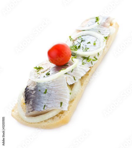 Sandwich with herring, onions, cherry tomato and herbs, isolated photo