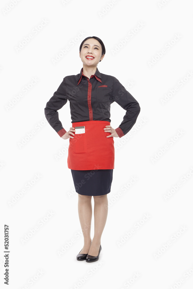 Young waitress, hand on hips, studio shot Young waitress, hand on hips, studio shot