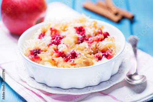 Rice pudding with applem raspberry and cinnamon photo