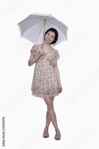 Young woman standing with umbrella