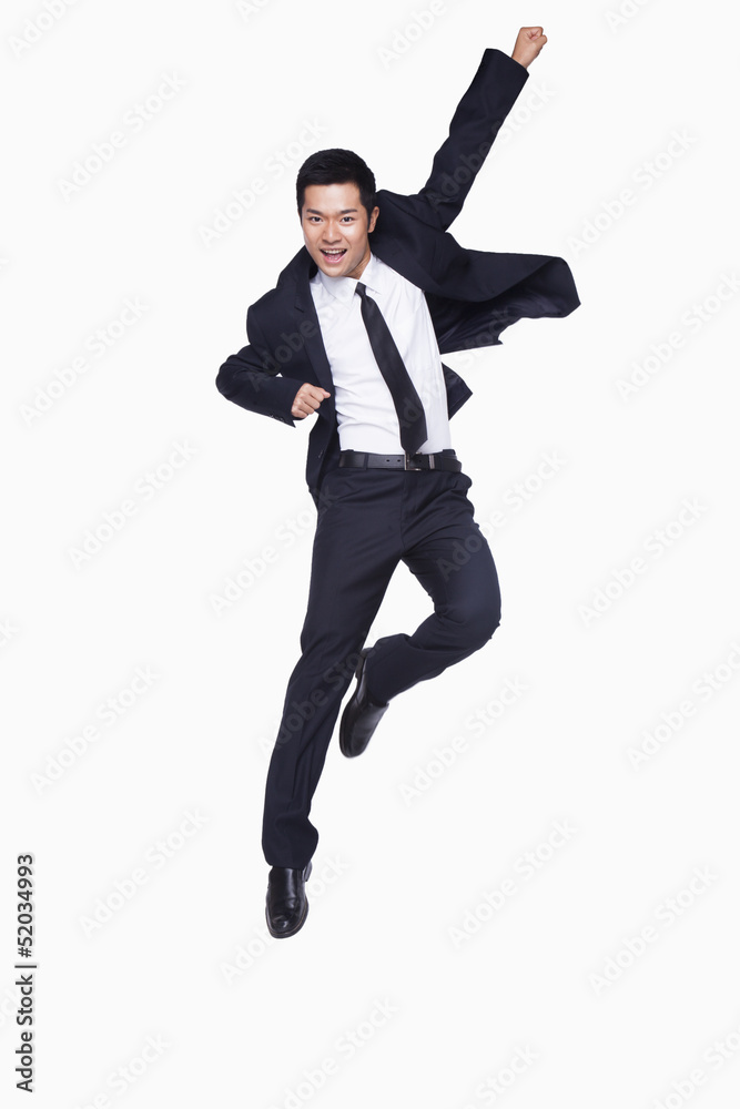 Young businessman jumping