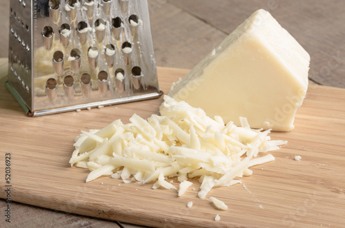 Parmesan cheese grated on a cutting board