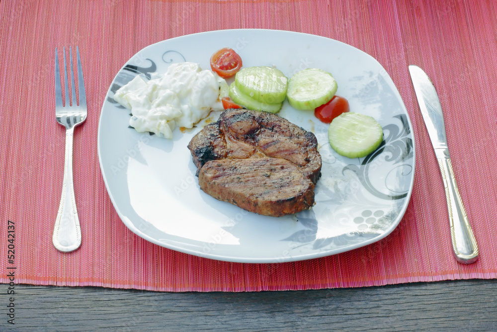 bbq grill on the plate on the table