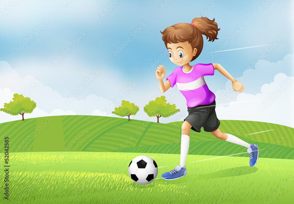 A girl playing soccer at the field