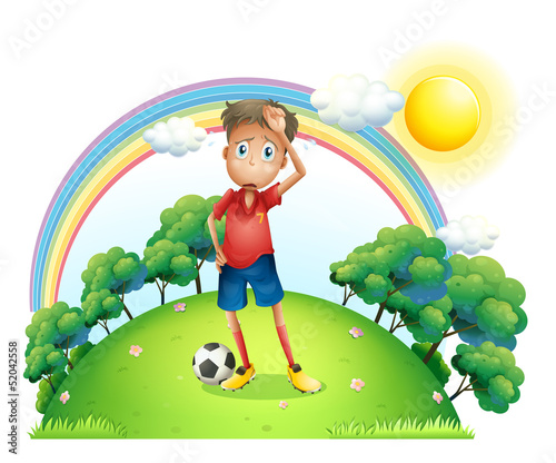 A tired soccer player at the top of the hill