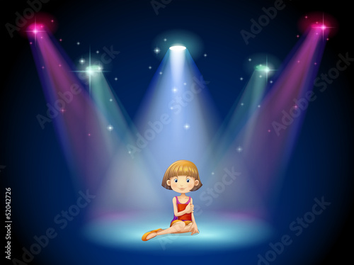 A girl acting on the stage with spotlights