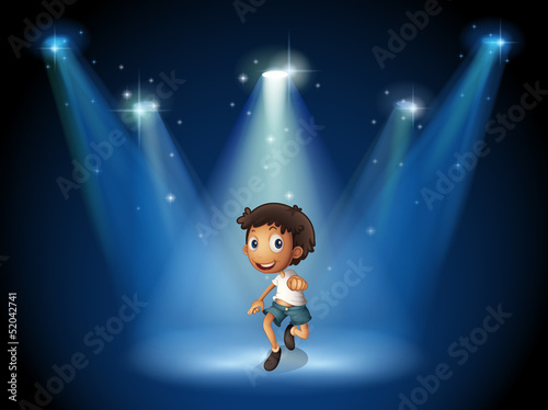 A boy dancing with spotlights