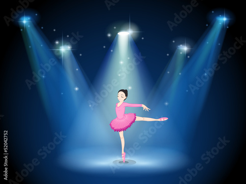 A lady in pink dancing ballet with spotlights