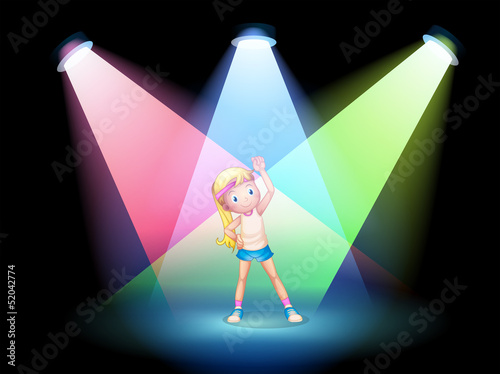A girl exercising on the stage with spotlights
