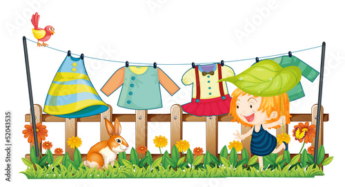 A child and a bunny near the hanging clothes
