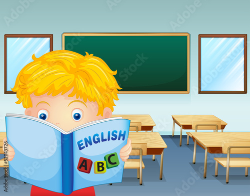 A kid reading inside the classroom